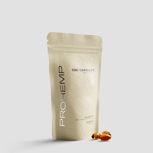 Beige resealable pouch labeled CBD capsules immune support with three softgel capsules in front.